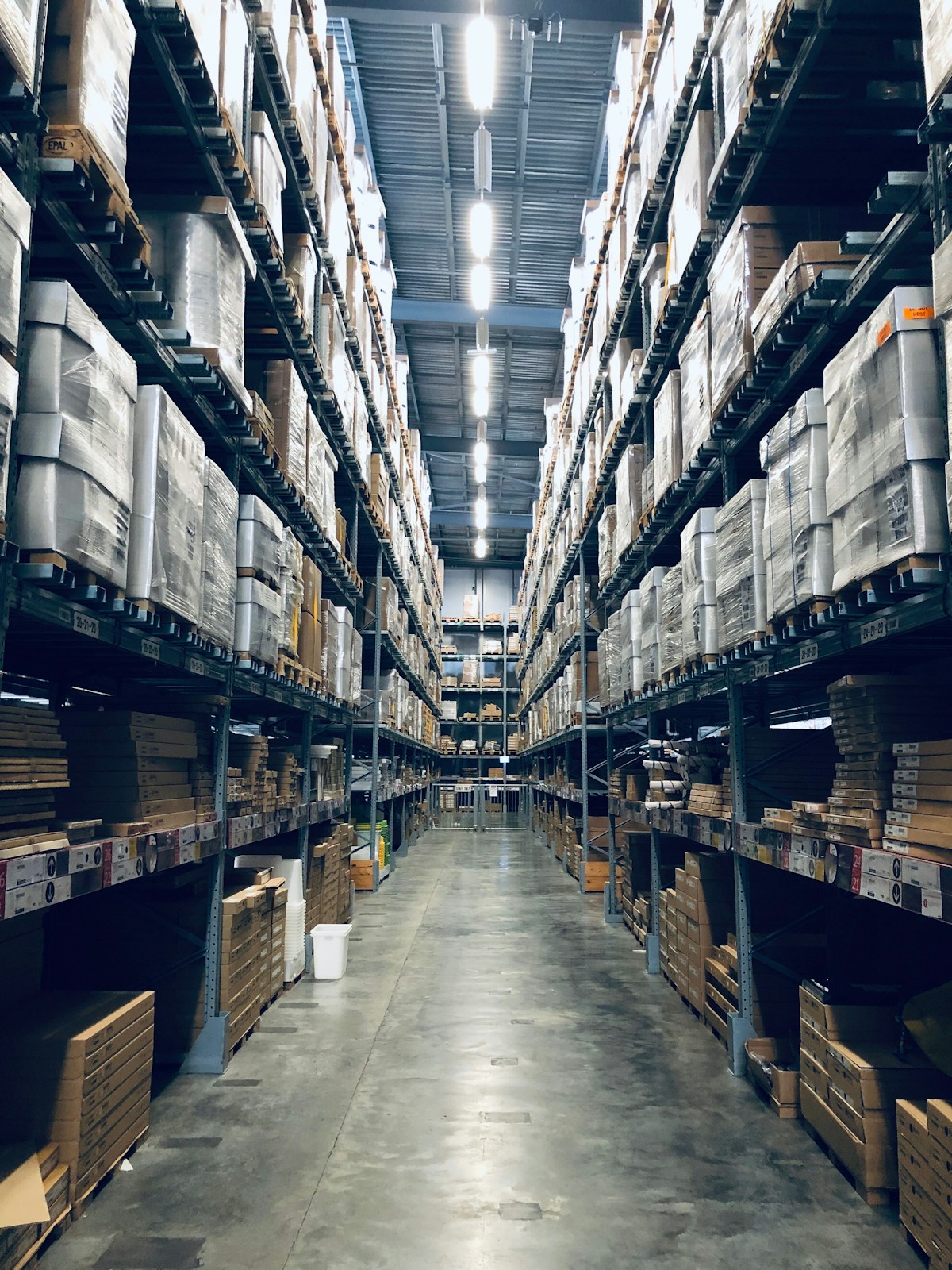 Warehouse aisle with organised inventory and boxed goods